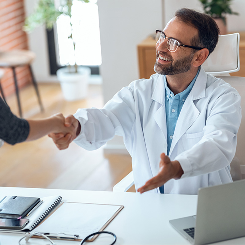 A doctor greeting a patient at Applewood Medical Clinic